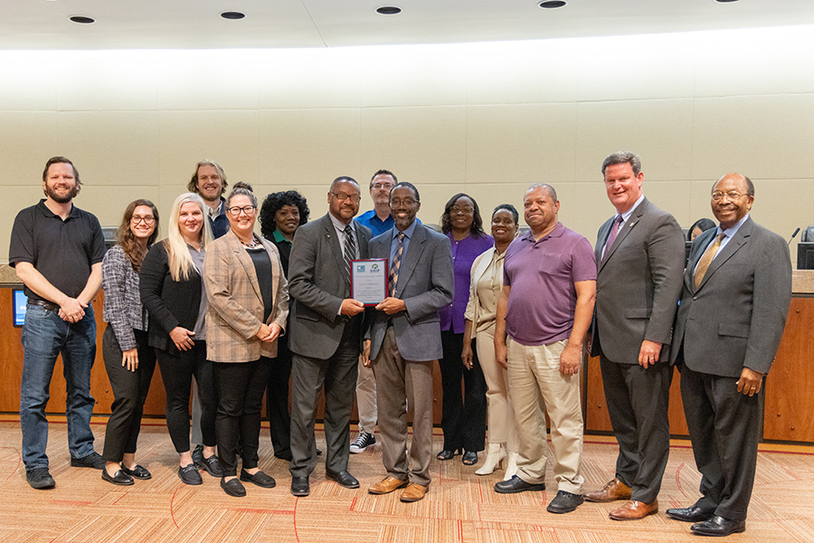 Commissioners and staff accept the award