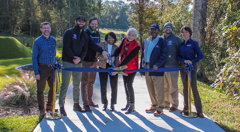 Officials gather for a ribbon cutting ceremony